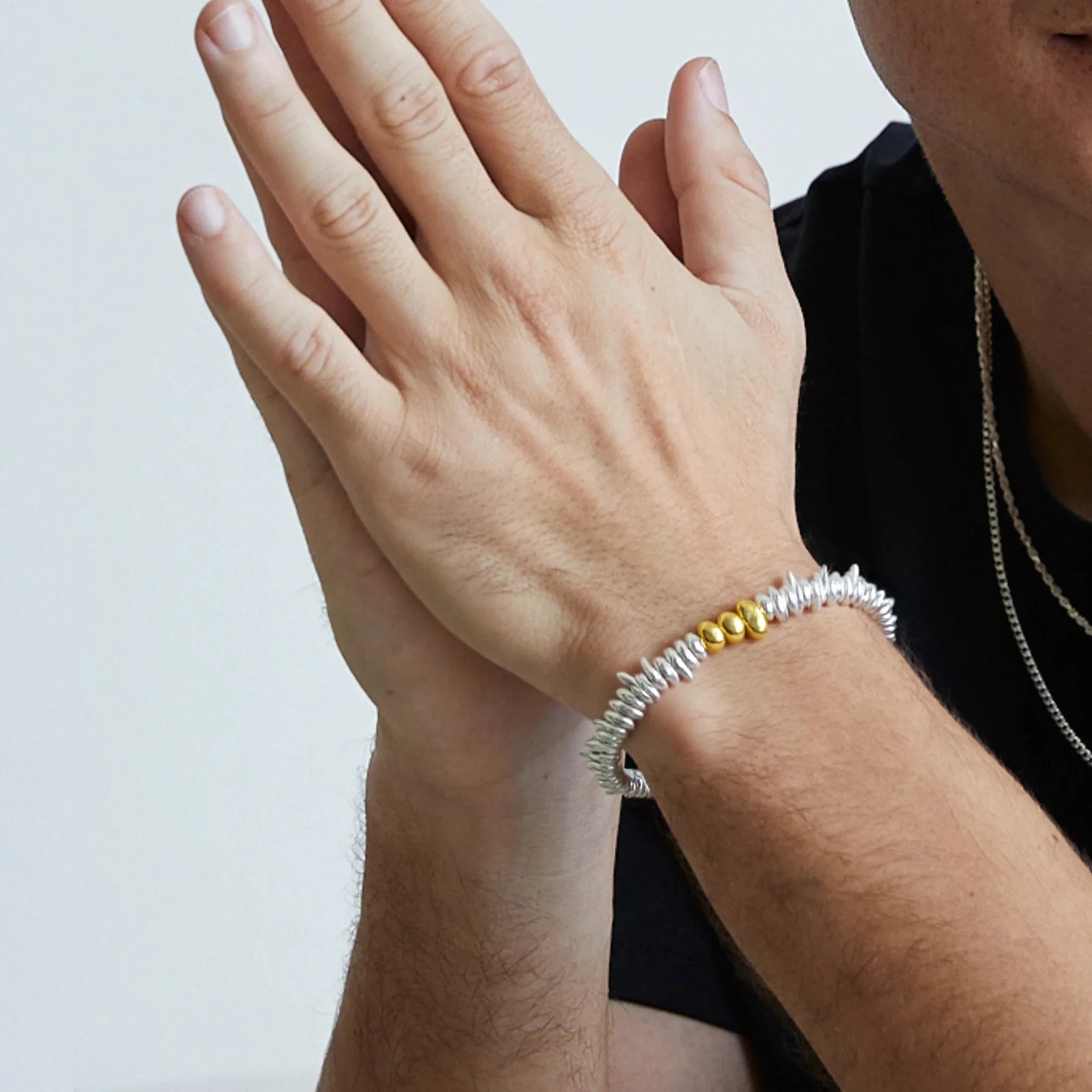 black agate bracelet with silver-plated accents worn on wrist