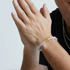 black agate bracelet with silver-plated accents worn on wrist