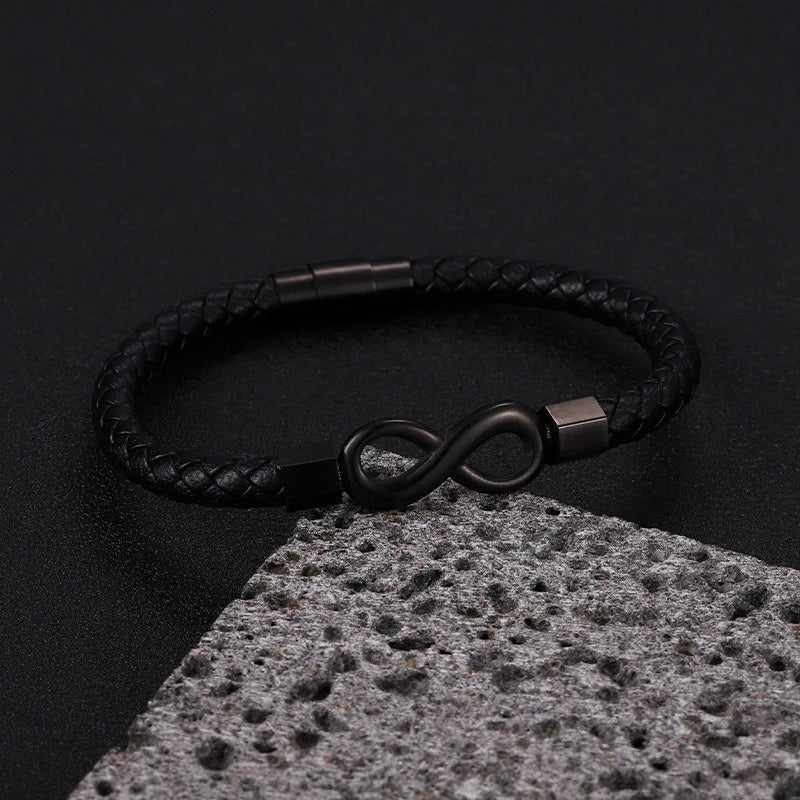 close-up of leather bracelet infinity symbol detail on table